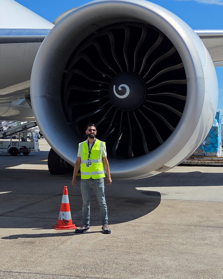 Visitor in front of an airplane engine